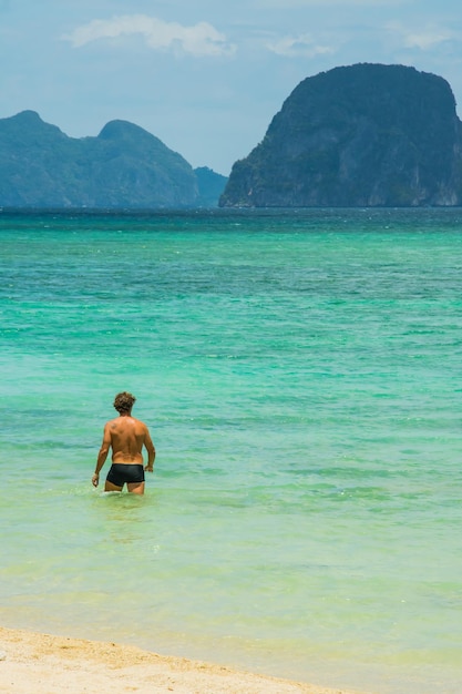 Foto vista posteriore di un uomo senza camicia in mare