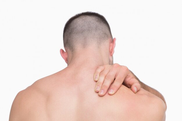 Rear view of shirtless man with neck pain