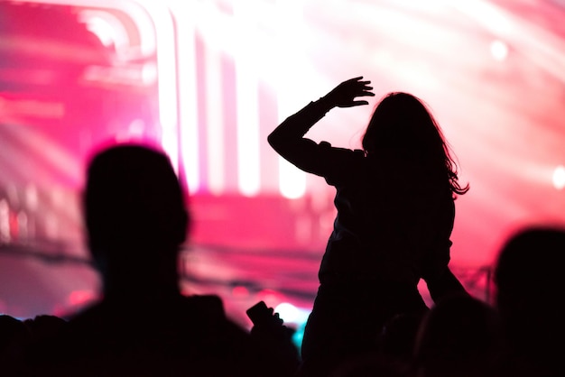 Rear view of a silhouette of a woman at concert