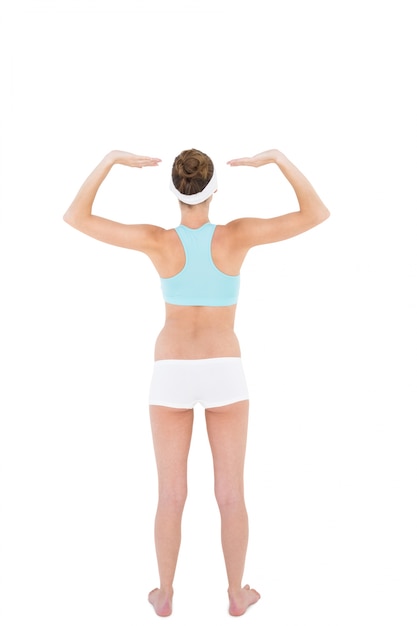 Photo rear view of slender woman wearing sportswear raising her arms