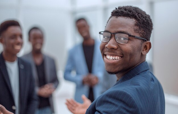 Rear view smiling young businessman looking at the camera