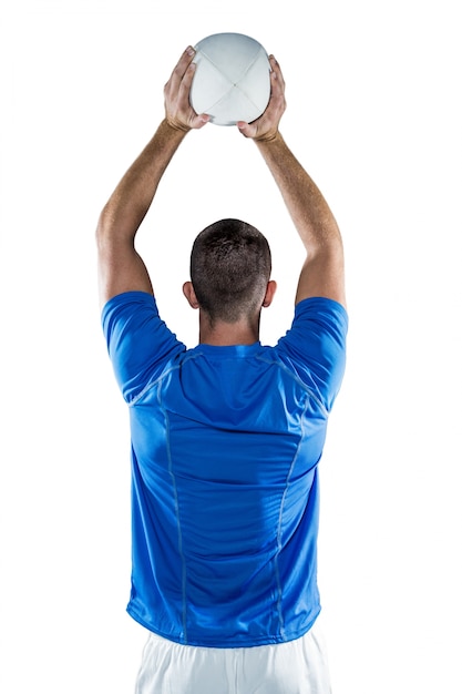 Rear view of sports player throwing ball