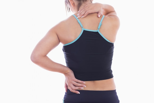 Rear view of sporty young woman massaging neck