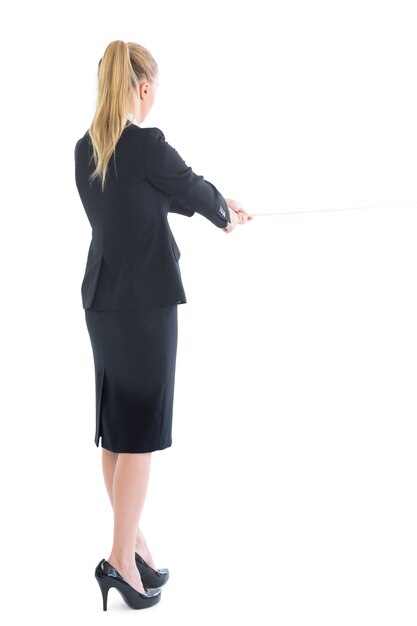 Rear view of standing business woman pulling a rope