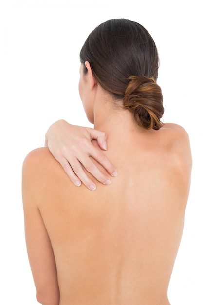 Rear view of a topless fit woman with shoulder pain