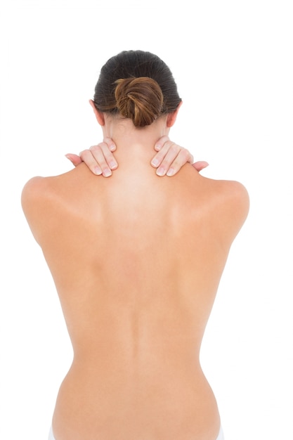 Photo rear view of a topless fit woman with shoulder pain