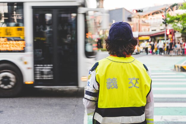 Rear view of traffic police standing on city street