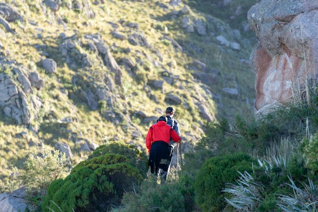 Rear view of Two Friends Hiking on a Mountain at Day TimeAdventure ConceptCopy Space