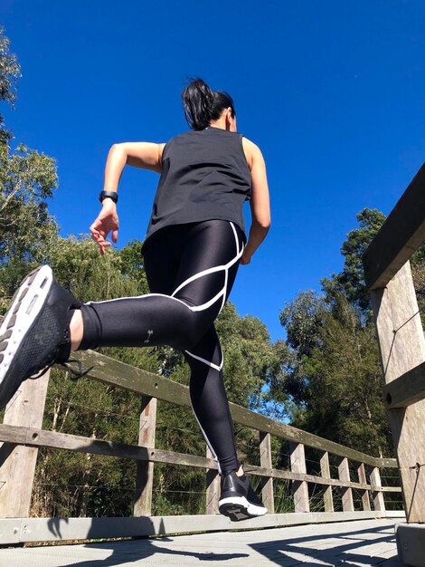 Rear view of woman against blue sky