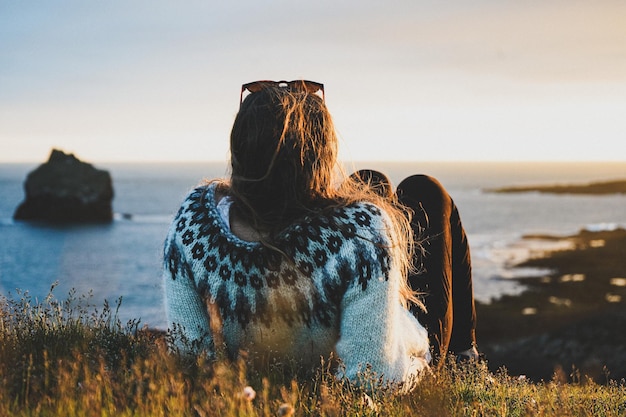 Photo rear view of woman at beach during sunset