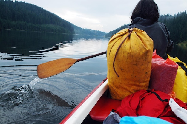 Rear view of woman in boat on lake