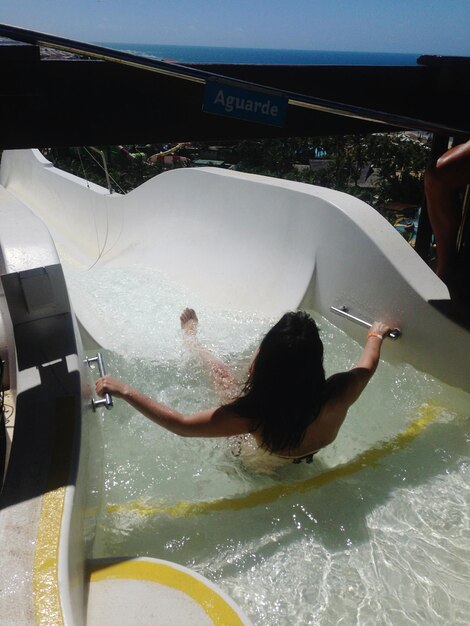 Rear view of woman enjoying water ride