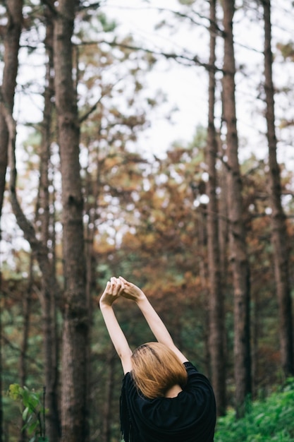 Rear view of woman in forest