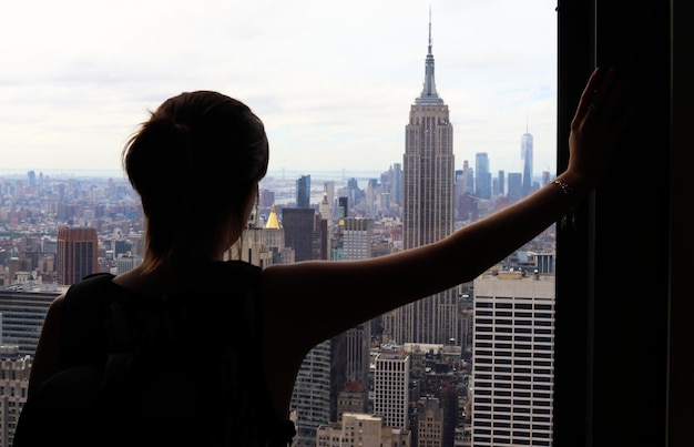 Rear view of woman looking at cityscape