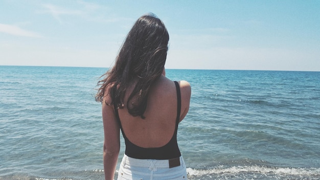 rear view of woman looking at sea