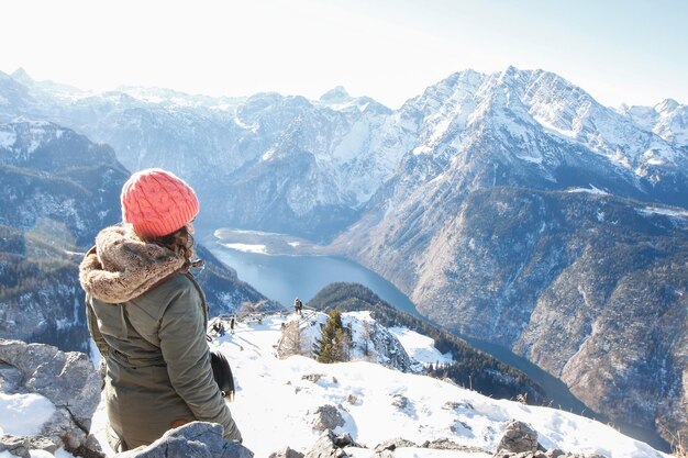 雪で覆われた山を見ている女性の後ろの景色