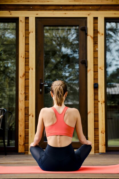 Rear view of woman in the lotus position outdoor