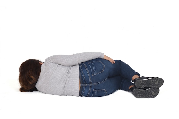 Rear view of a woman lying on the floor on white background