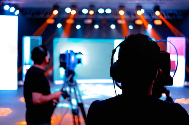 Rear view of woman photographing at music concert