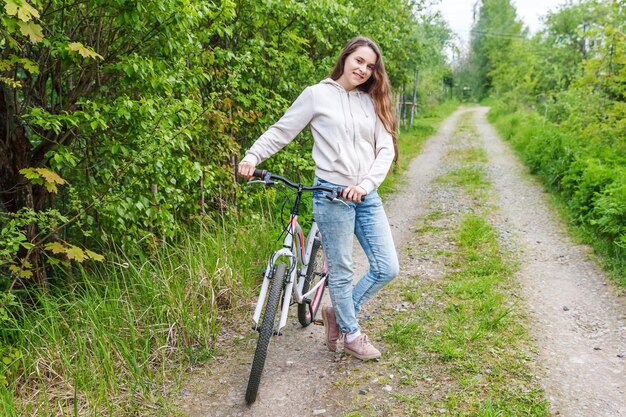 Rear view of woman riding bicycle on field