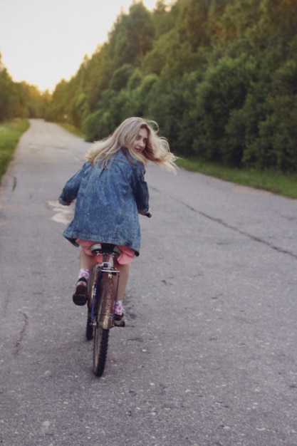 Rear view of woman riding bicycle on street