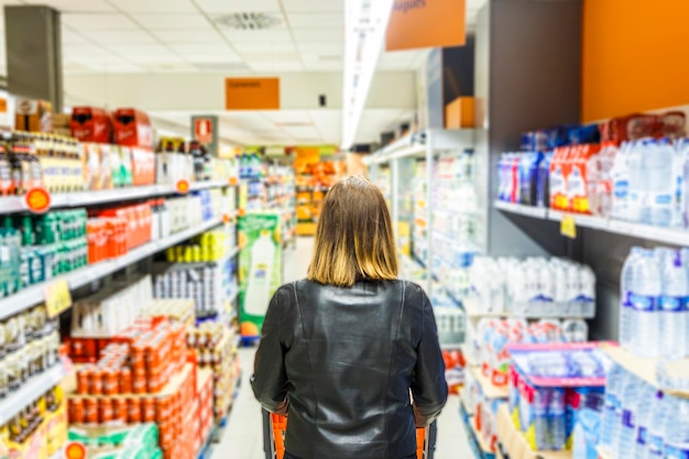 rear view of woman shopping at supermarket