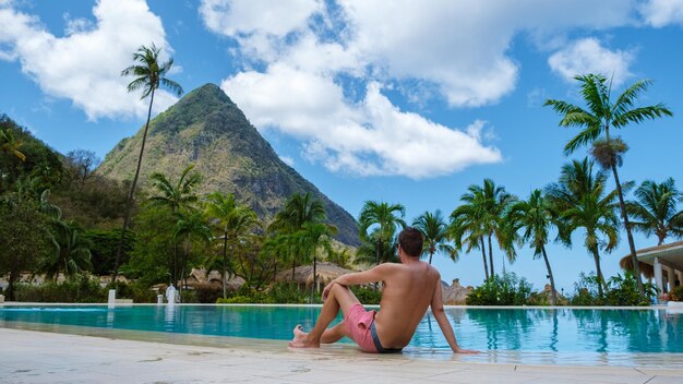 Rear view of woman sitting on beach against sky