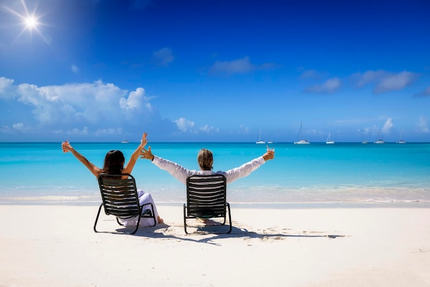 Photo rear view of woman sitting on beach against sky