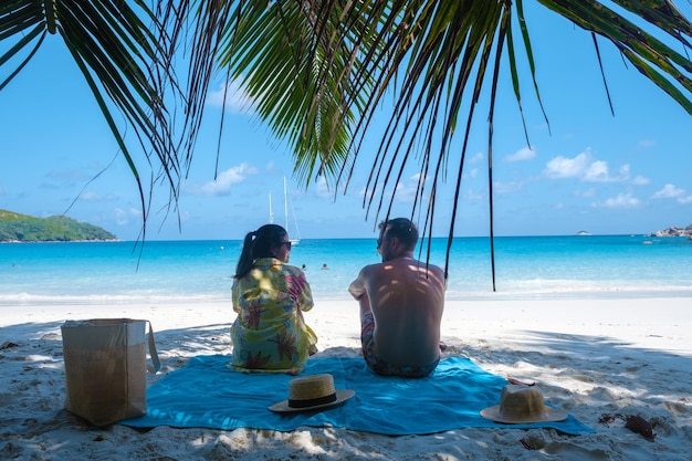 Rear view of woman sitting on beach