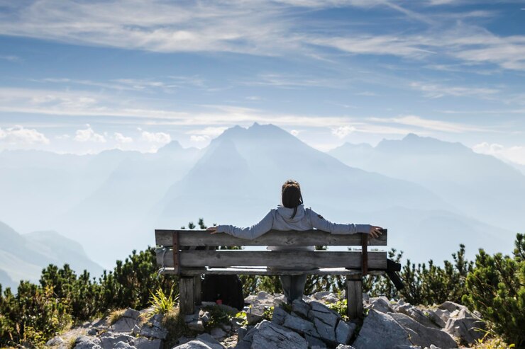 Photo rear view of woman sitting on bench against sky