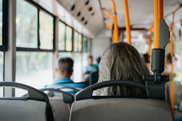 rear view of woman sitting in bus