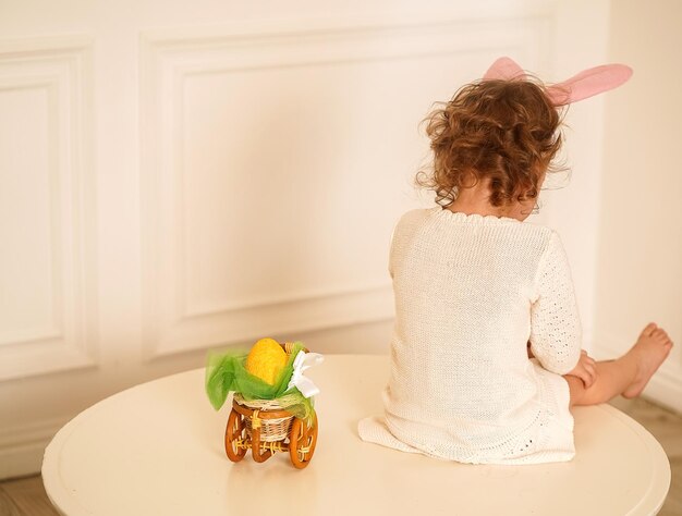 Rear view of woman sitting on table at home