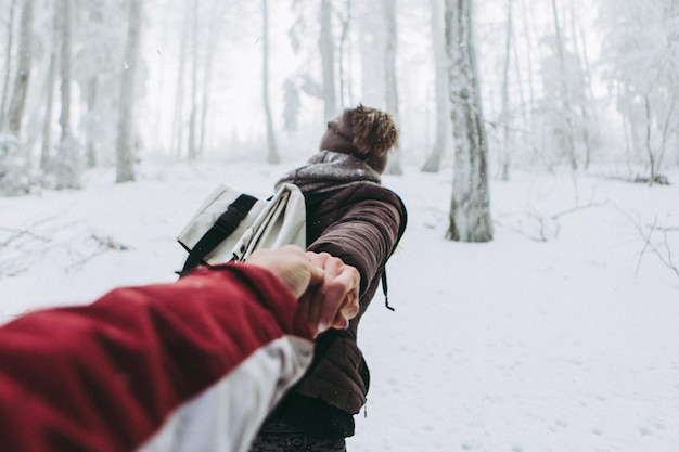 Foto vista posteriore di una donna su un paesaggio coperto di neve