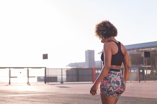 Rear view of a woman in sportive clothes outdoors