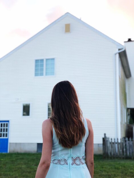 Photo rear view of woman standing against building