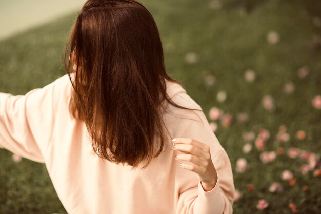 Rear view of woman standing against plants