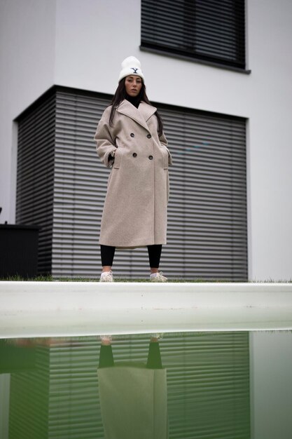 Rear view of woman standing against window