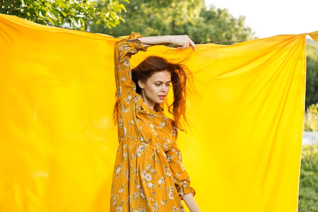 Rear view of woman standing against yellow wall