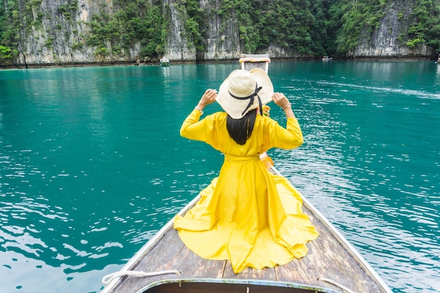 Rear view of woman standing against yellow water