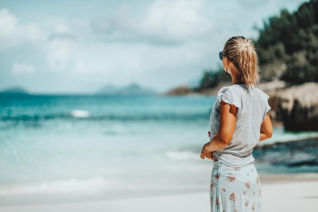 Rear view of woman standing at beach