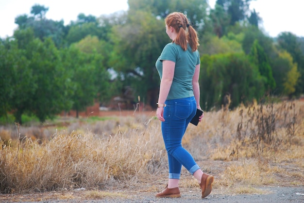 Rear view of woman standing on field