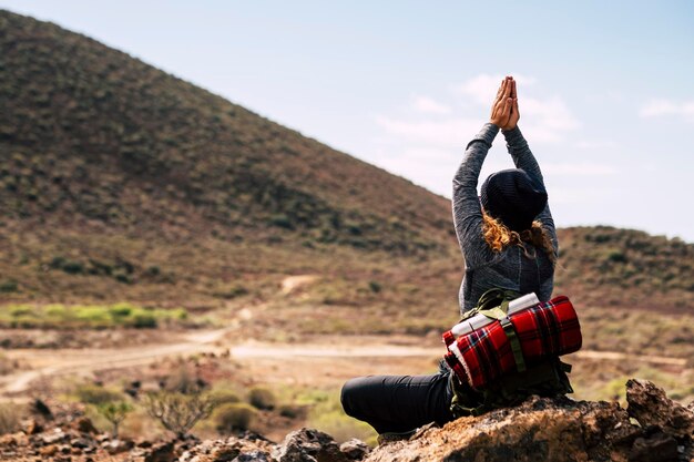 Rear view of woman standing on mountain