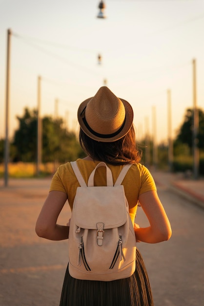 rear view of woman standing on road against sky