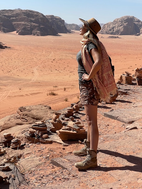 Rear view of woman standing on rock