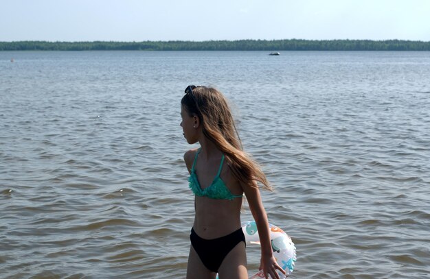 Rear view of woman standing in sea