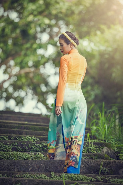 Rear view of woman standing on steps