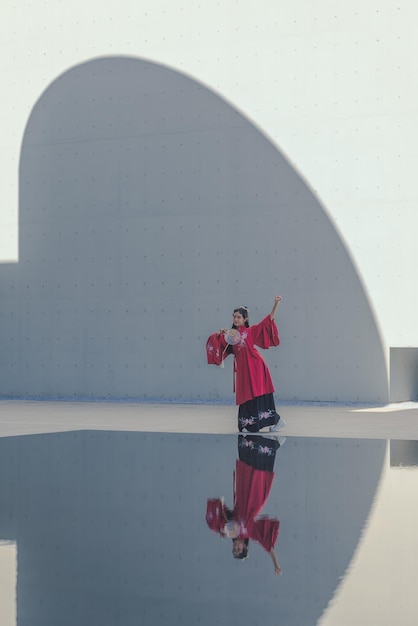 Rear view of woman standing on wall