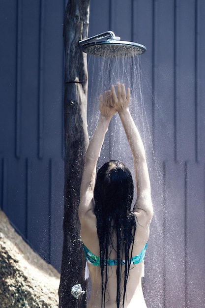 Rear view of woman standing in water