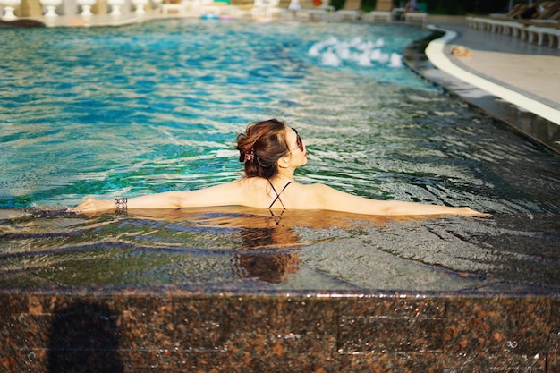 Rear view of woman in swimming pool
