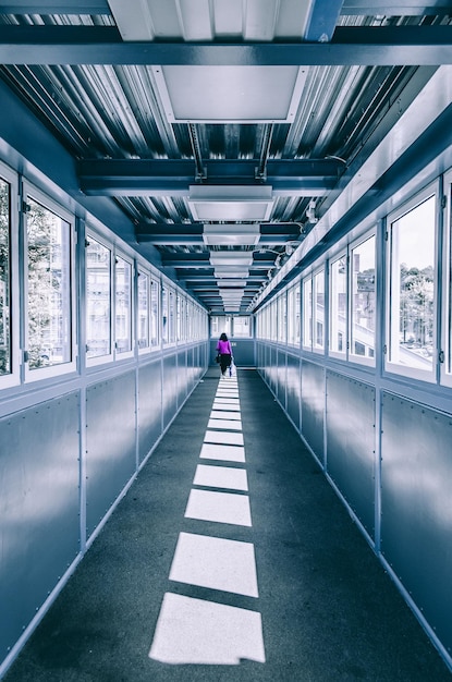 Photo rear view of woman walking in covered walkway